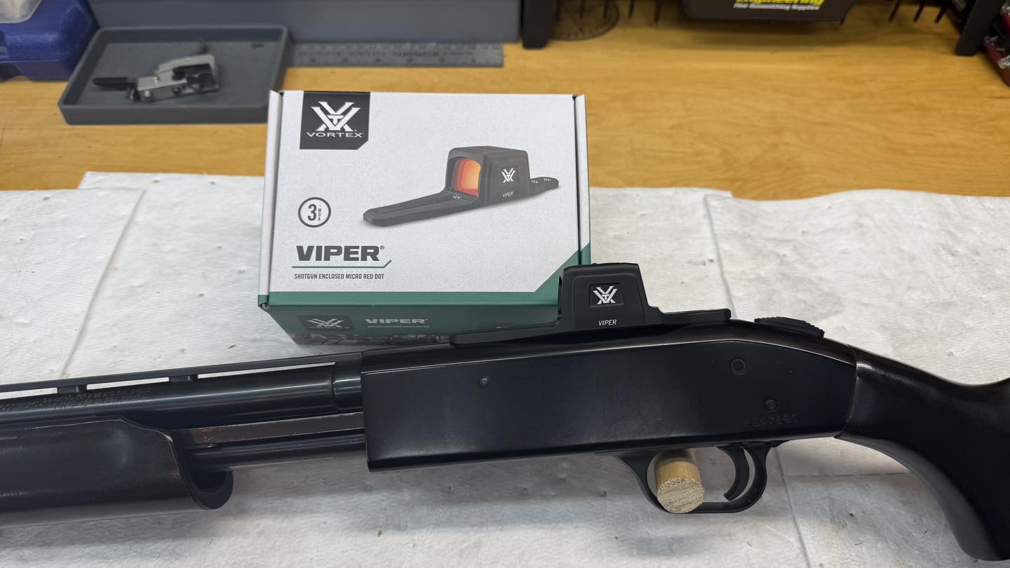 Red dot sight installed on shotgun receiver